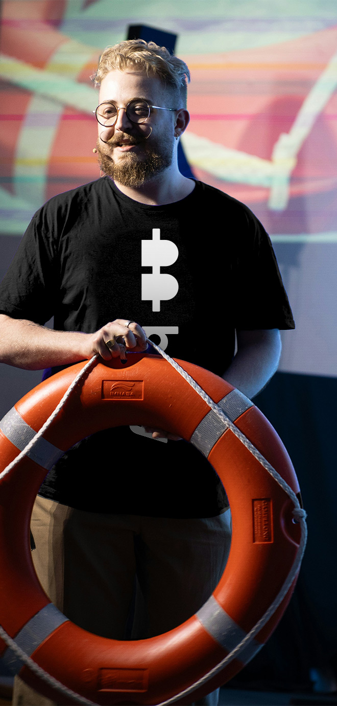 man on stage with buoy shirt holding a buoy